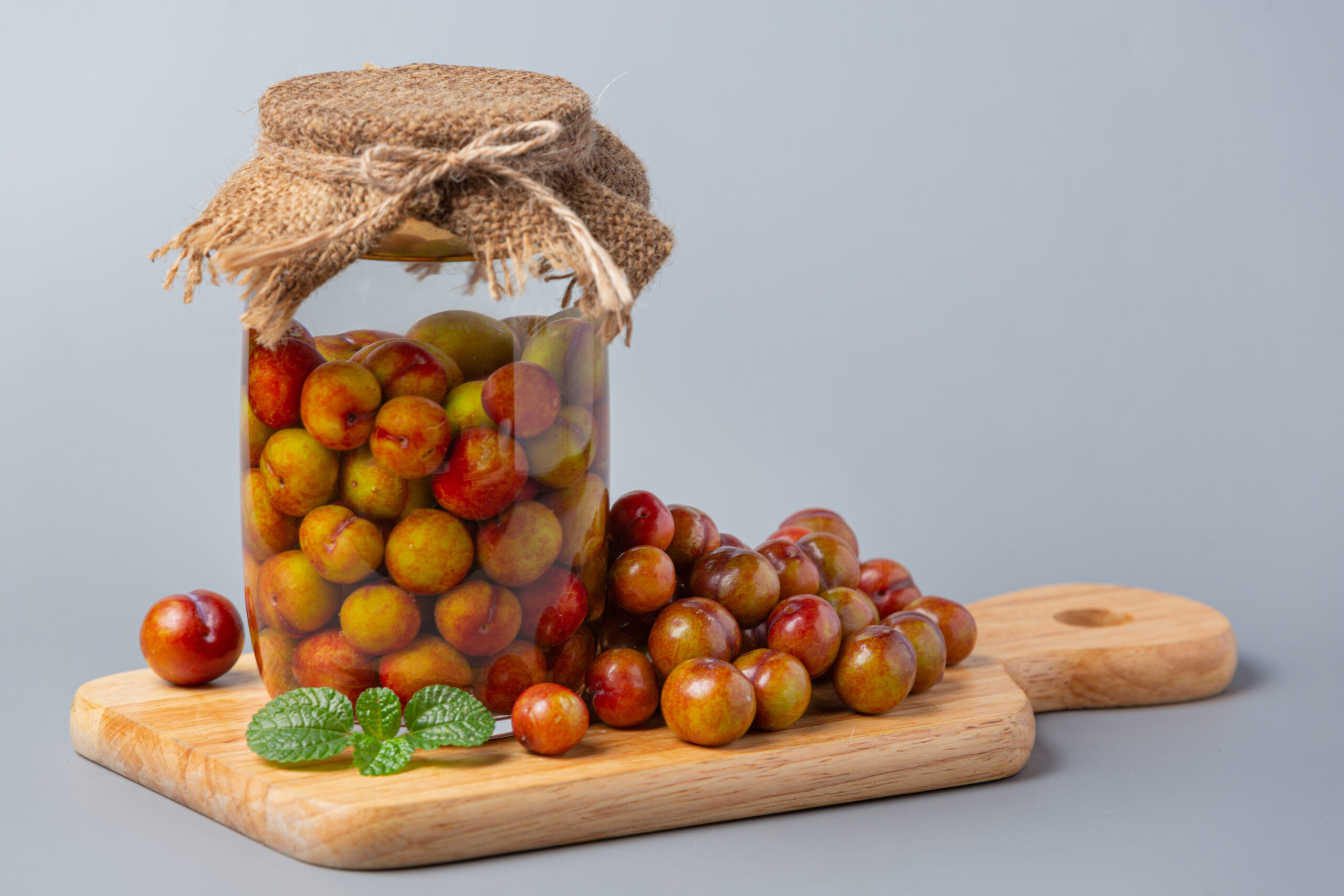 Pickled Plums on gray background.